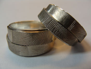 Trouwringen met ingewalste vingerafdruk in zilver en witgoud